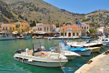 Fototapeta na wymiar Boats moored in the bay of the island of Symi, Dodecanese, Greece
