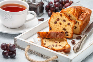 Homemade freshly baked cake loaf with raisins. Traditional treat for tea or coffee. Pound cake. Delicious breakfast. Selective focus