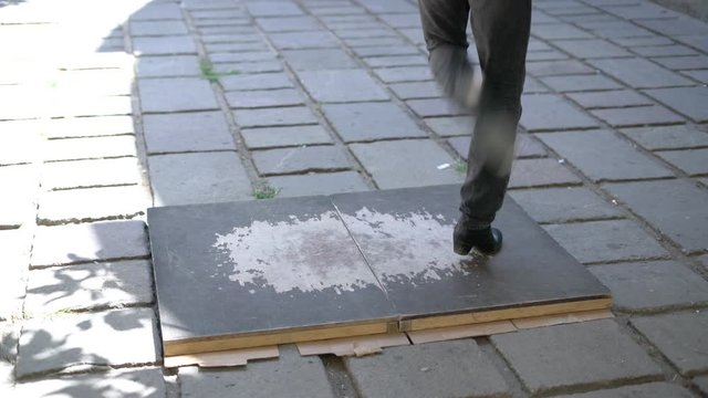 legs of a street dancer during tap dance in sunny weather