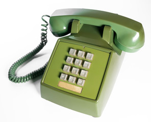 Retro push button rotary dial telephone. Vintage avocado green landline phone.