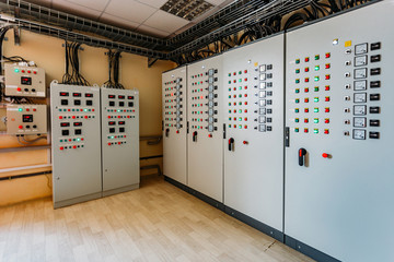 Electrical switchgear cabinets with control panels with indicator lights in factory 