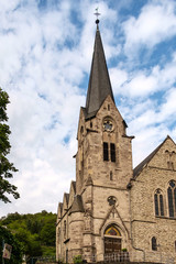 Fototapeta na wymiar Markuskirche in Braubach am Rhein vor blauem Himmel mit weißen Wolken