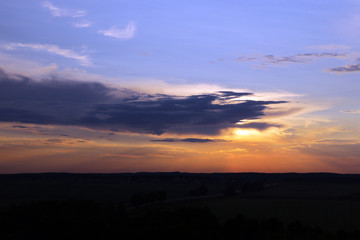 Beautiful sunset sky above clouds with dramatic light.