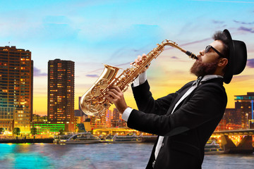 Man playing a saxophone with a view of a city