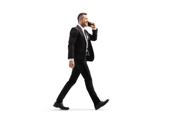 Businessman walking and talking on a mobile phone