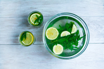 making mojito drink top view on a light wood background. Hot Summer. refreshing drink