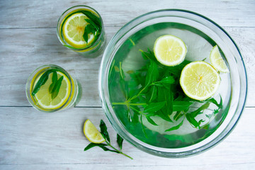 making mojito drink top view on a light wood background. Hot Summer. refreshing drink