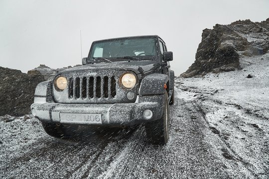 VIK, ICELAND - MAY 03, 2018: Jeep Wrangler Unlimited Four Wheel Drive Vehicle On A Mountain Road With Snow