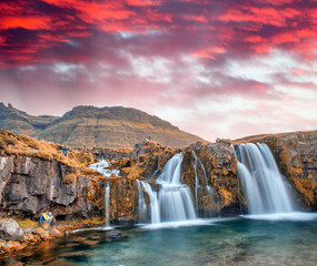 Famous travel location in Iceland. Kirkjufell Waterfalls at sunset, long exposure