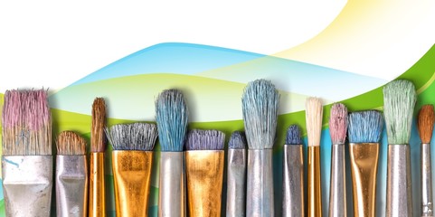 Row of artist paint brushes  on abstract bokeh background