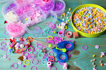 Fototapeta na wymiar Children's set for creativity. Beads, scissors and pencils.