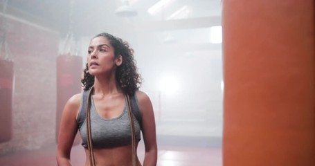 Portrait of strong mixed race female in boxing gym