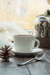 Fall cozy still life on windowsill at home interior. Cup of coffee at home warm fluffy furskin. Hygge concept. Creativity and inspiration.