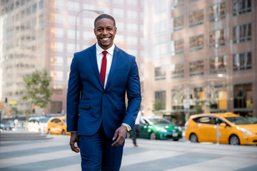 Proud, confident, accomplished, successful, cheerful African American businessman walking...