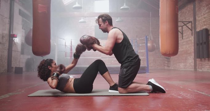Mid adult female with fitness trainer
