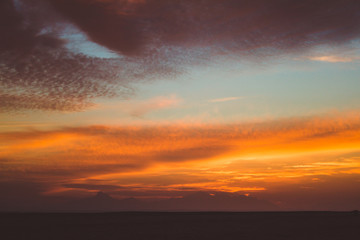 Naklejka na ściany i meble beautiful sunset colors, sun peaking into clouds 