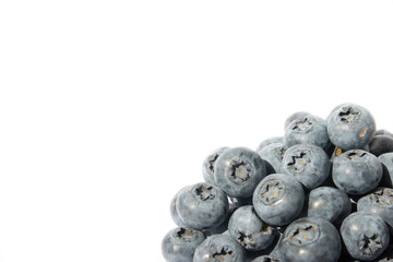 A group of blueberries in the right corner of the frame on white background. Fresh blueberries. Selective focus. Free space for text.