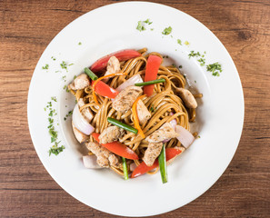 Tallarin saltado traditional peruvian meal. On a white plate