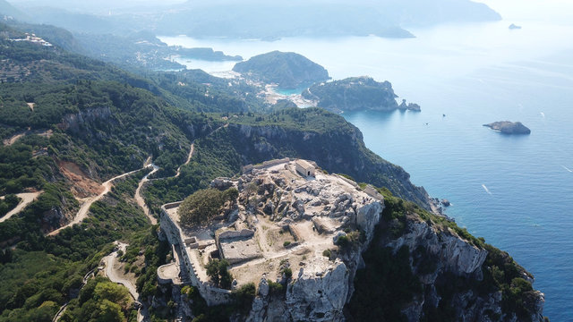 Aerial drone view of iconic medieval fortified castle of Aggelokastro with amazing views to Paleokastritsa bay, Corfu Greece