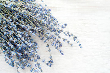 Bouquet with dried lavender on white wooden background top view