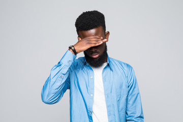 Closeup portrait of young male, shy man closing covering eyes with hands can't see, hiding,...