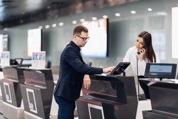 handsome businessman handing over air ticket at airline check in counter