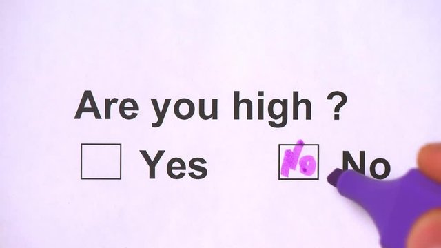 Overhead shot of a caucasian man answering to the question: Are you high? on the white piece of sheets