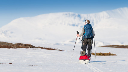 Fototapeta na wymiar Woman enjoying the view over a mountain range in snow