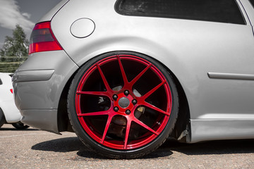 red candy colored light alloy wheels on silver hatchback