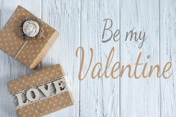 Be my Valentine. Greeting card with gift boxes and the word Love. Greeting card for Valentine's Day. Flat lay, top view.