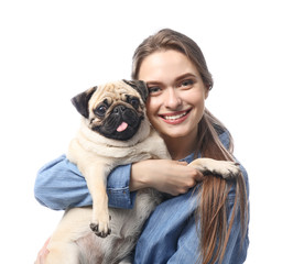 Beautiful young woman with cute pug dog on white background