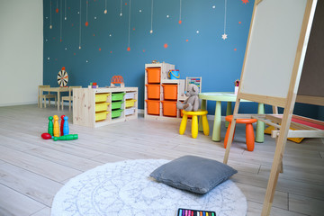 Stylish interior of modern playroom in kindergarten