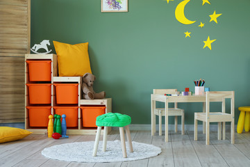 Stylish interior of modern playroom in kindergarten