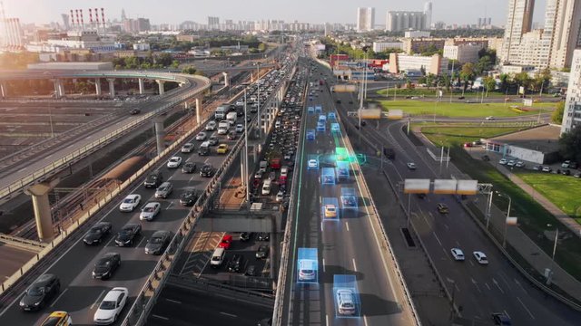 Beautiful aerial presentation of the autonomous cars self-driving concept on multi-level highway in Moscow. Picturesque aerial panorama of the road traffic in a big city on the evening.