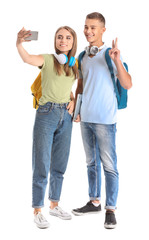 Obraz premium Portrait of young students taking selfie on white background
