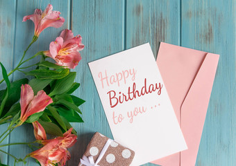 Happy Birthday to You. Birthday greeting card with flowers on a wooden background. Greeting card...