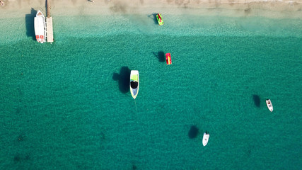 Fototapeta na wymiar Aerial top view photo of sun beds and umbrellas in popular tropical paradise deep turquoise Mediterranean sandy crowded beach