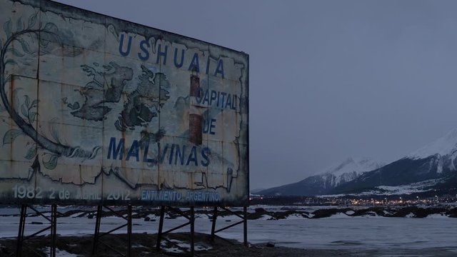 CLOSE UP View Of Old Sign Board To Ushuaia By Side Of Road In The Late Evening