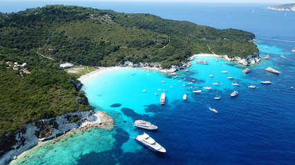 Aerial drone photo of tropical paradise turquoise beach of Voutoumi with sail boats docked in...