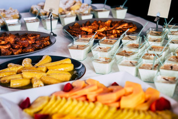 Catering and restaurant table with tasty cakes and fruit -coloured food and job concept