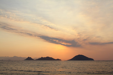 Obraz na płótnie Canvas Seascape at sunset. Lighthouse on the coast