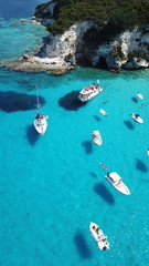 Aerial drone photo of beautiful exotic paradise turquoise sandy beach of Voutoumi with sail boats docked in island of Anti paxos, Ionian, Greece - obrazy, fototapety, plakaty