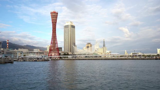 Seaside view of the Kobe Port Tower from Mosaic Garden side overlooking the water. Pan left.
