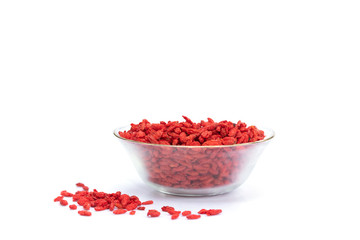 dried goji berries in glass cup isolated on white backgrownd