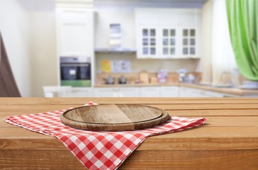 Wooden board stand on tablecloth over grunge background