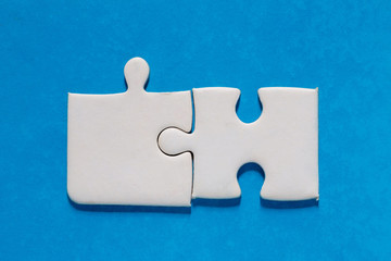 Unfinished white jigsaw puzzle pieces