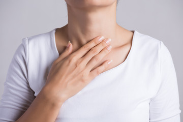 Sore Throat. Closeup Of Beautiful Young Woman Hand Touching Her Ill Neck. Healthcare and medical...