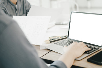 Mockup image of engineers using laptop to drawing design building Project in office, mockup concept