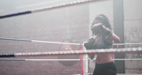 Female boxer preparing in the ring