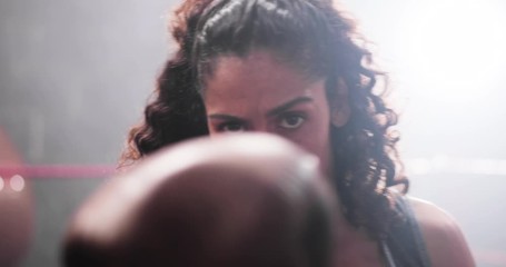 Female boxer punching to camera
